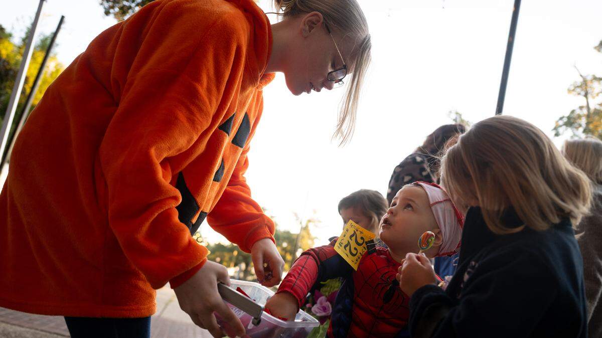 Eli Hillner accepts candy during Boo On The Rue in Biloxi on Thursday, October. 30, 2025.