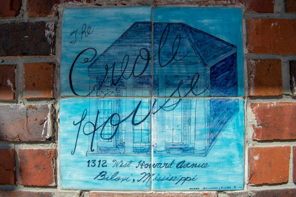 Tiles embedded in the front of Milton Grishman’s real estate office label the building as “The Creole House” on Wednesday, Feb. 9, 2022. Inspired by New Orleans, Grishman’s father Moody added the tiles after he bought the building in the 1960s.