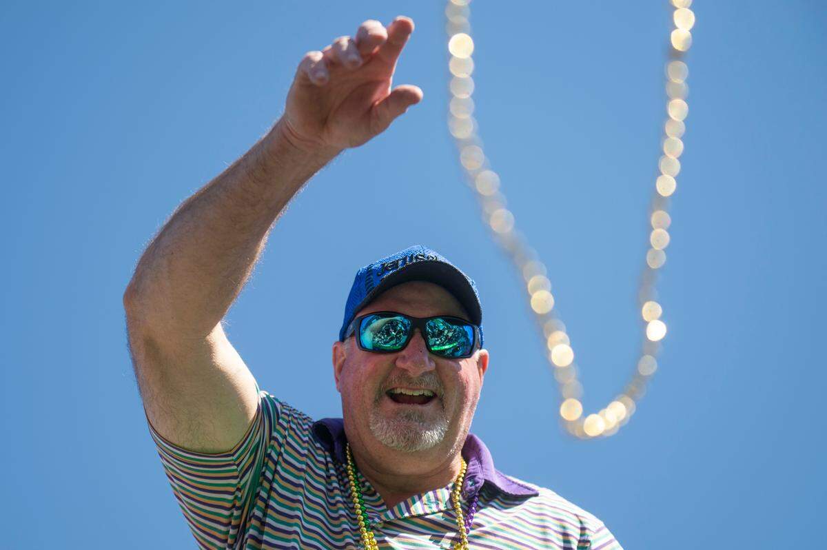 Krewes toss beads and other throws during the Jackson County Carnival Association Mardi Gras parade in Pascagoula on Saturday, March 1, 2025.
