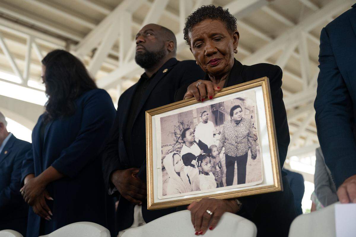 Christene Brice holds a picture of her assisting people left homeless by Hurricane Katrina.
