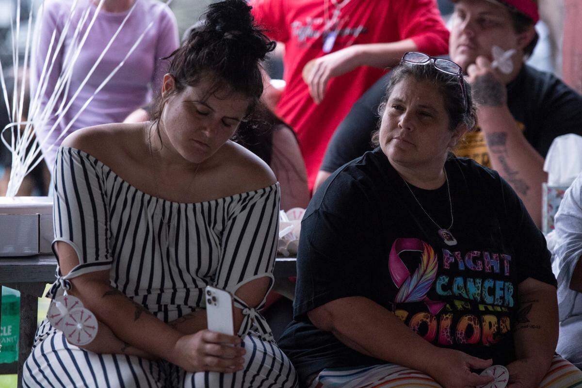 Family members listen to a service during a candlelight vigil in remembrance of Gracelynn Vick at Saucier Park on Tuesday, April 22, 2025.