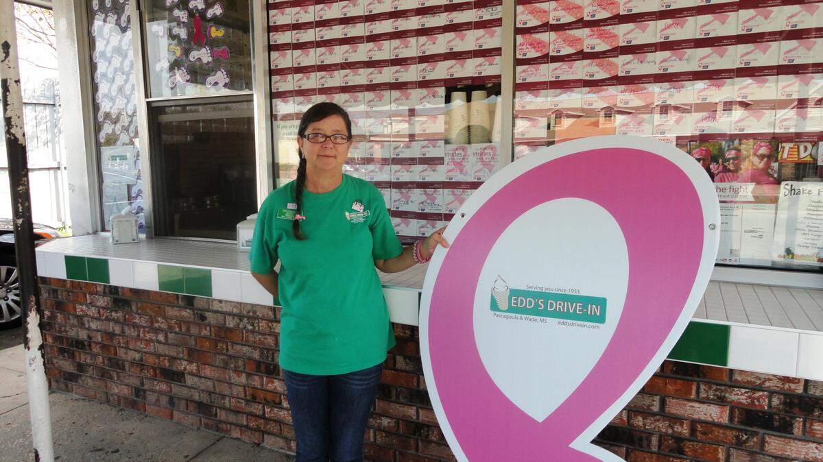VICKI TERRINONI/SPECIAL TO THE SUN HERALDBreast cancer survivor Becky Hasty shows off the sign she and other employees at Edd's Drive-In in Pascagoula received for raising more than $1,000 for the American Cancer Society Making Strides for Breast Cancer Walk. Hasty will display the sign at the walk on Saturday at the Biloxi Town Green.