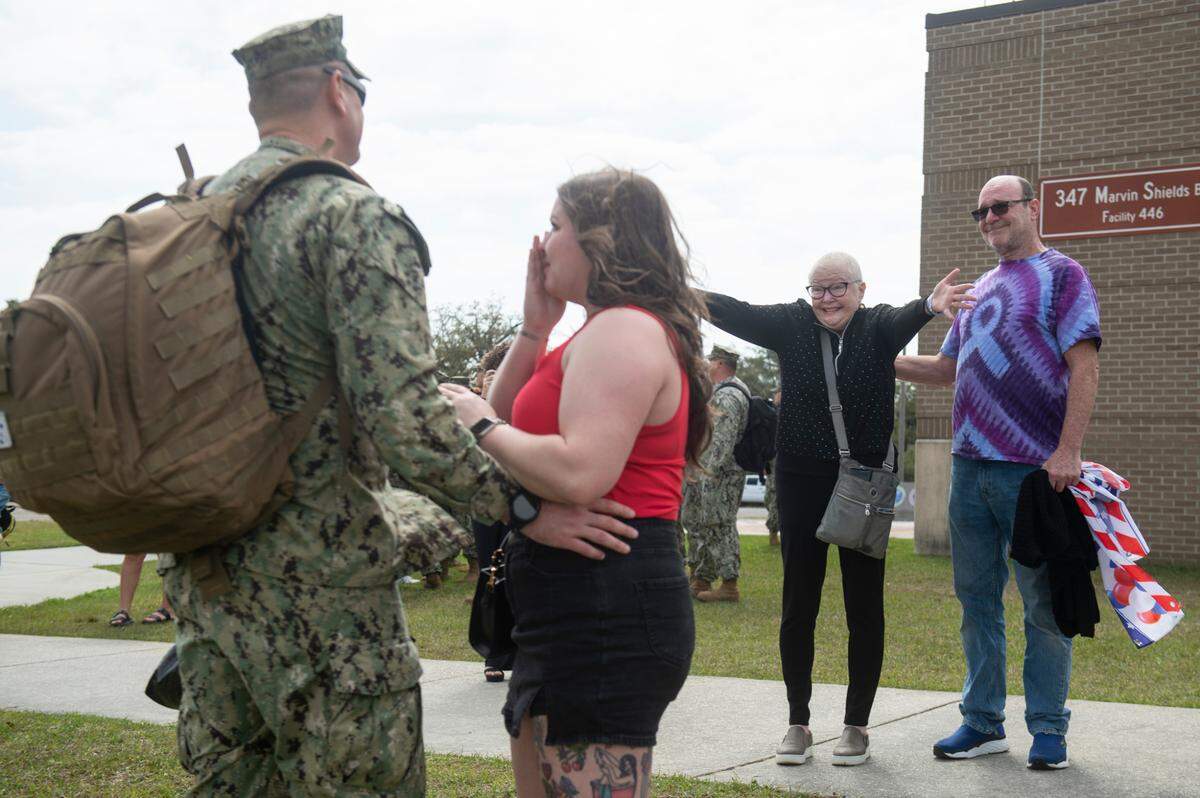 Dawn Riedel waits for a hug from her son Jared Anton, a members of Naval Mobile Construction Battalion 1, as he returns home to his wife and parents from deployment on Thursday, March 13, 2025, to Naval Construction Battalion Center Gulfport.