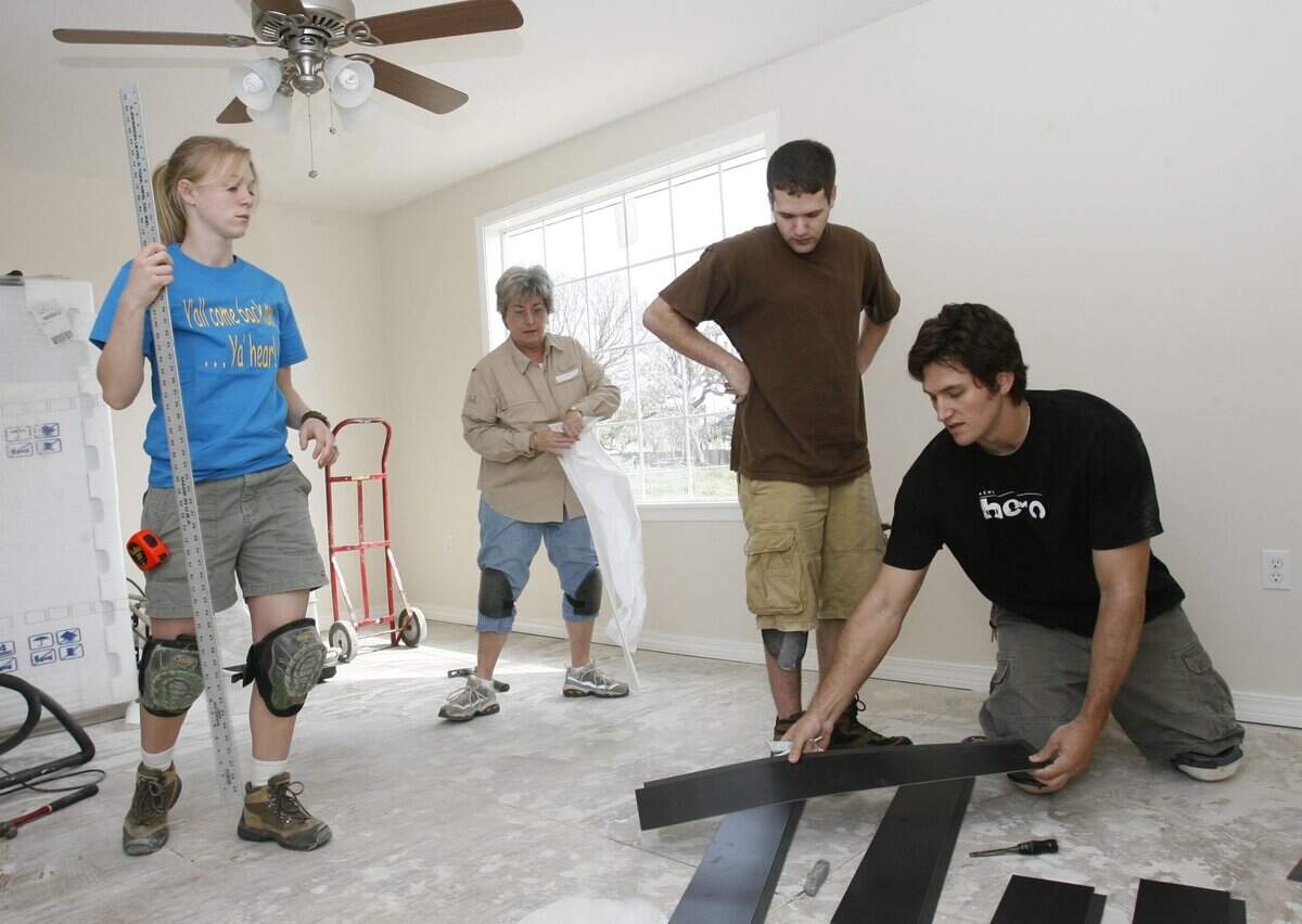 Carleigh Neumeister, left, and Mark Neumeister, right, of Costa Mesa, Ca., work Wednesday with fellow Lutheran Disaster Response Team volunteers Linda Krieger of Lehighton, Pa., and Matt Berlowitz of Columbia, Md.