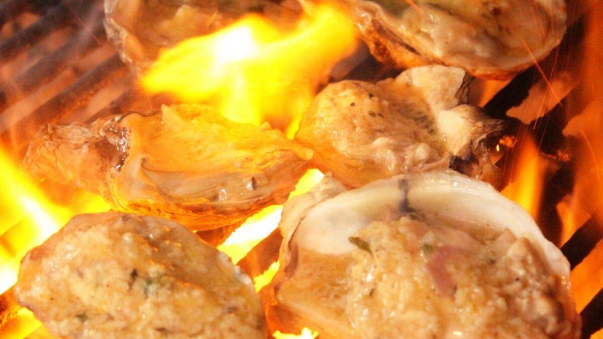 JULIAN BRUNT/SPECIAL TO THE SUN HERALDOysters are grilled over an open fire.