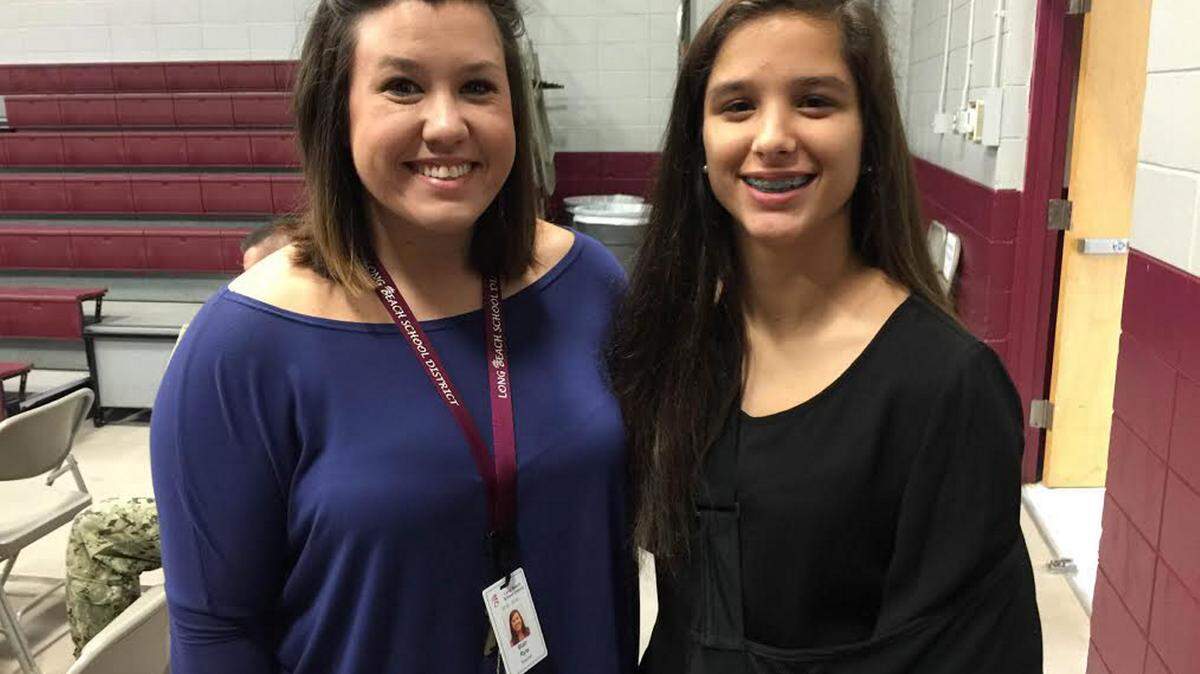 JEFF CLARK/SPECIAL TO THE SUN HERALD 
 Long Beach Middle School Student Council sponsor Blair Ryle and council president Abby Duvisson welcome veterans to the campus of Long Beach Middle School on Tuesday, Nov. 10, 2015.