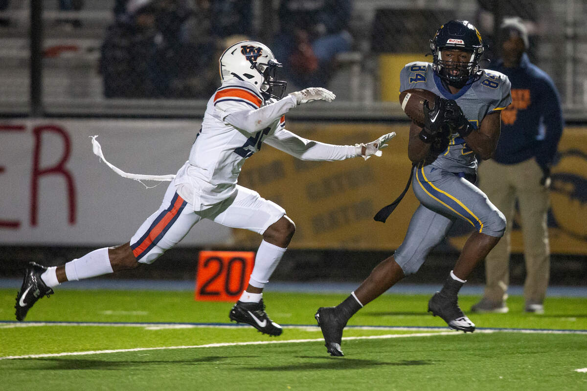 Gautier’s Dillon Alfred catches a pass from Gautier quarterback Kaden Irving during a playoff game against Wayne County at Gautier High School in Gautier on Friday, Nov. 11, 2022.
