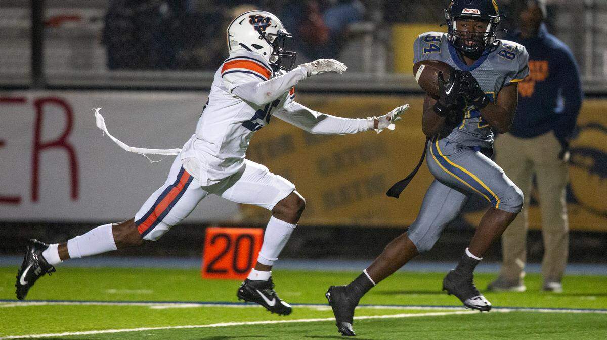 Gautier’s Dillon Alfred catches a pass from Gautier quarterback Kaden Irving during a playoff game against Wayne County at Gautier High School in Gautier on Friday, Nov. 11, 2022.