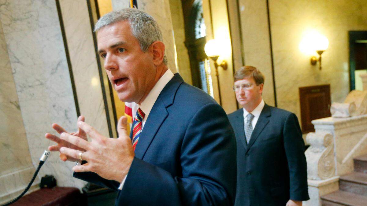 House Speaker Philip Gunn, R-Clinton, left, outlines the shared goals of fellow Republicans Gov. Phil Bryant, right, and Lt. Gov. Tate Reeves to move toward a total comprehensive budget and tax reform with the development of a legislative panel to review tax policy and provide recommendations to the Legislature at a news conference at the Capitol in Jackson, Miss., Thursday, July 14, 2016.