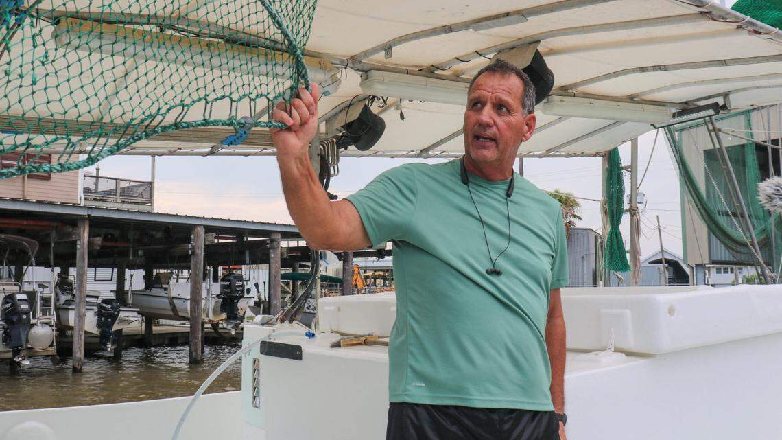 Thomas Olander, on his boat in Cypremort Point, Louisiana, shows off the nets his family uses to catch shrimp in Vermilion Bay.