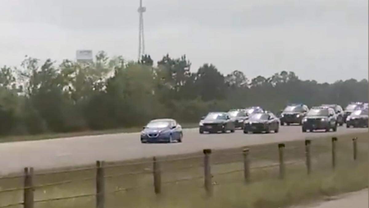 This screenshot of a video taken by a driver on Interstate 10 shows the blue Altima driven by Eric Derrell Smith being chased by law enforcement on Monday, May 3, 2021.