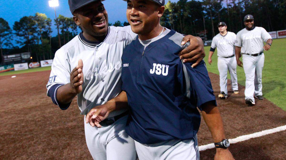 JONATHAN BACHMAN/ASSOCIATED PRESS 
 Jackson State head coach Omar Johnson, right, is congratulated by former third baseman Dylan Parker after beating Louisiana-Lafayette in Lafayette, La., on May 30, 2014.