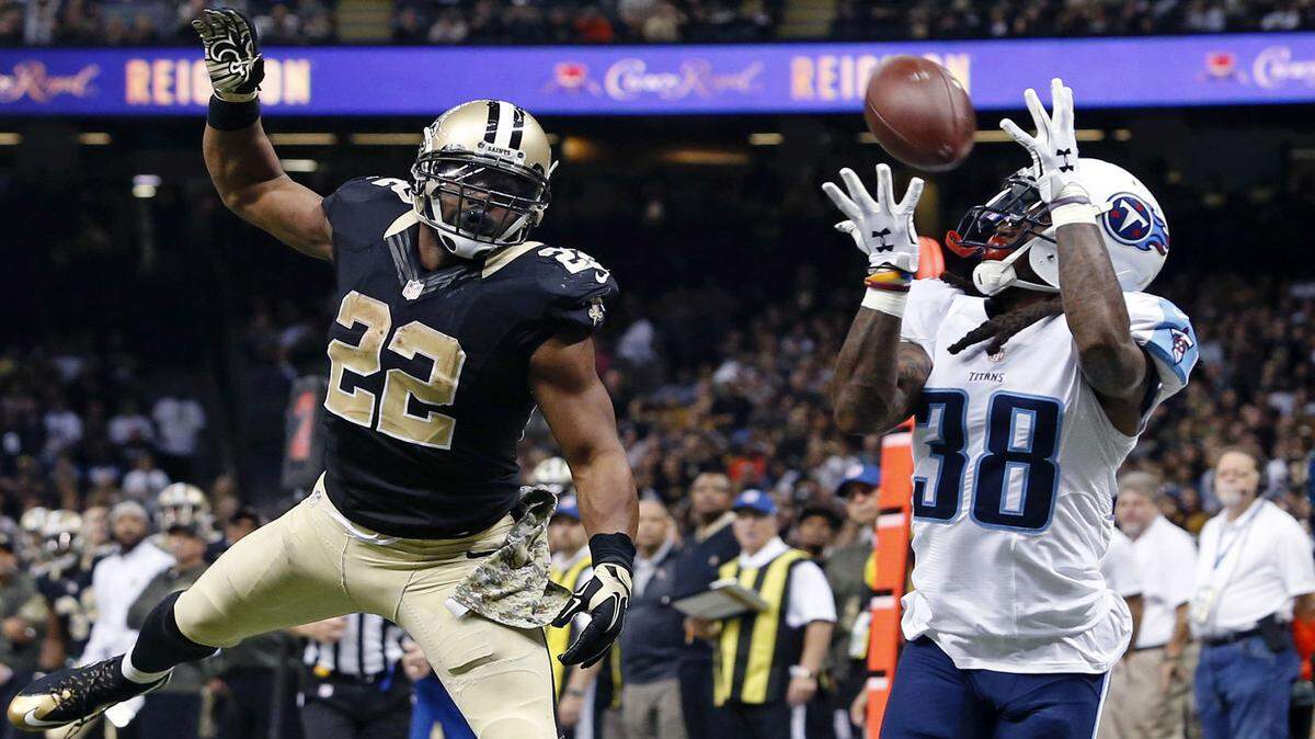 Tennessee Titans cornerback B.W. Webb (38) pulls in an interception on a pass intended for New Orleans Saints running back Mark Ingram (22) in the second half of an NFL football game in New Orleans, Sunday, Nov. 8, 2015. (AP Photo/Jonathan Bachman)
