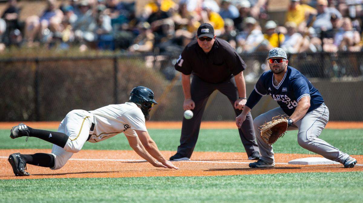 Southern Miss’ Matthew Etzel dives to make it back to first base during the first game of a double header against Georgia Southern at Pete Taylor Park on Saturday, March 25, 2023.