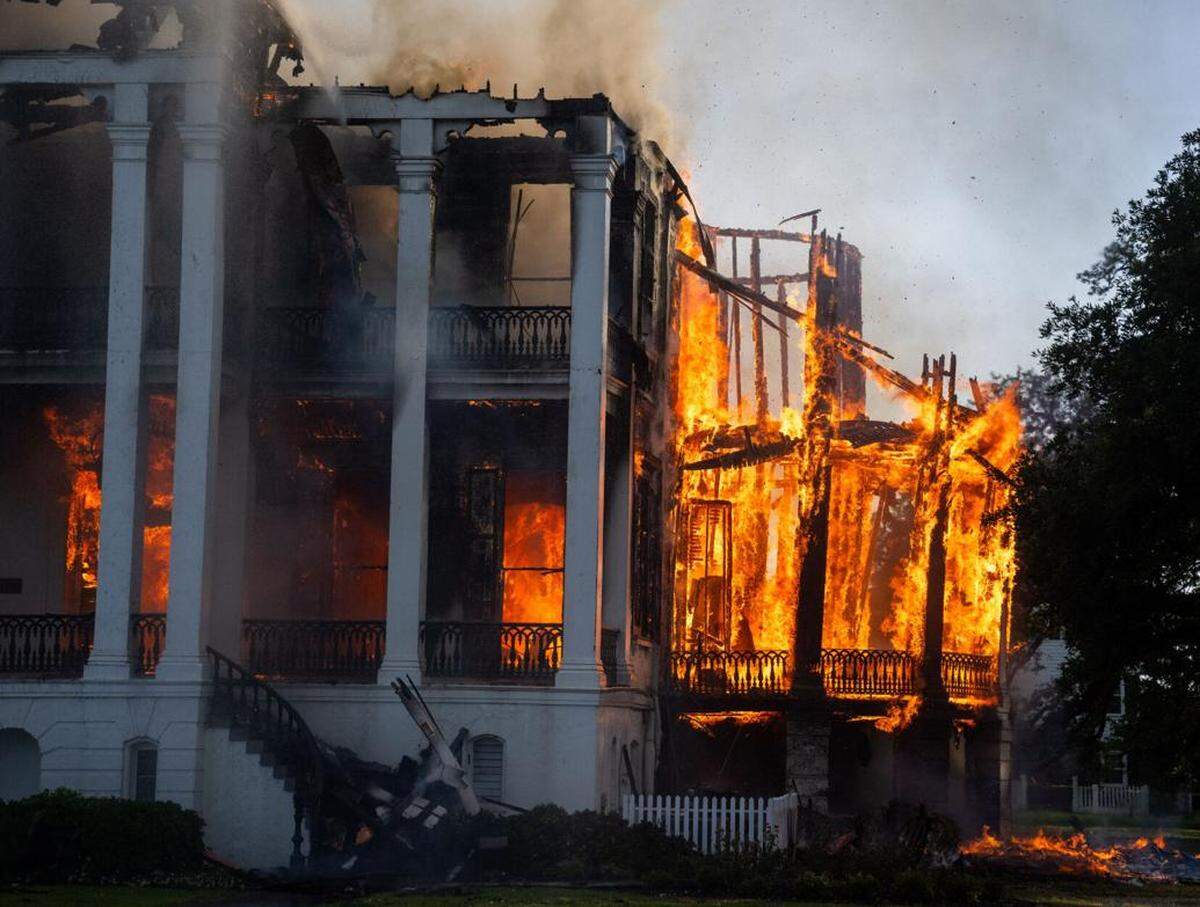 The north wing of the Nottoway Plantation starts to collapse as crews battle the fire on Thursday, May 15, 2025, in White Castle, Louisiana.