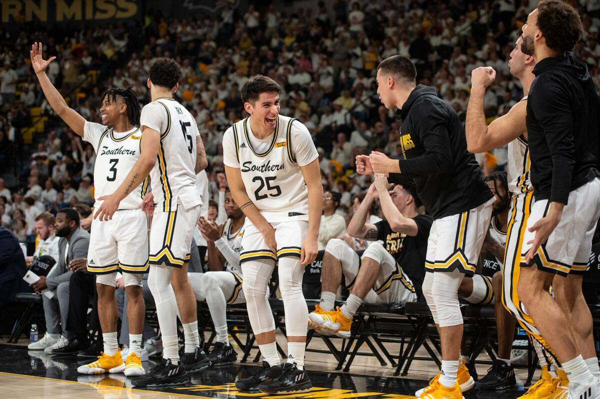 The Southern Miss bench celebrates during a game against Louisiana-Lafayette at Reed Green Coliseum on Thursday, Feb. 9, 2023.