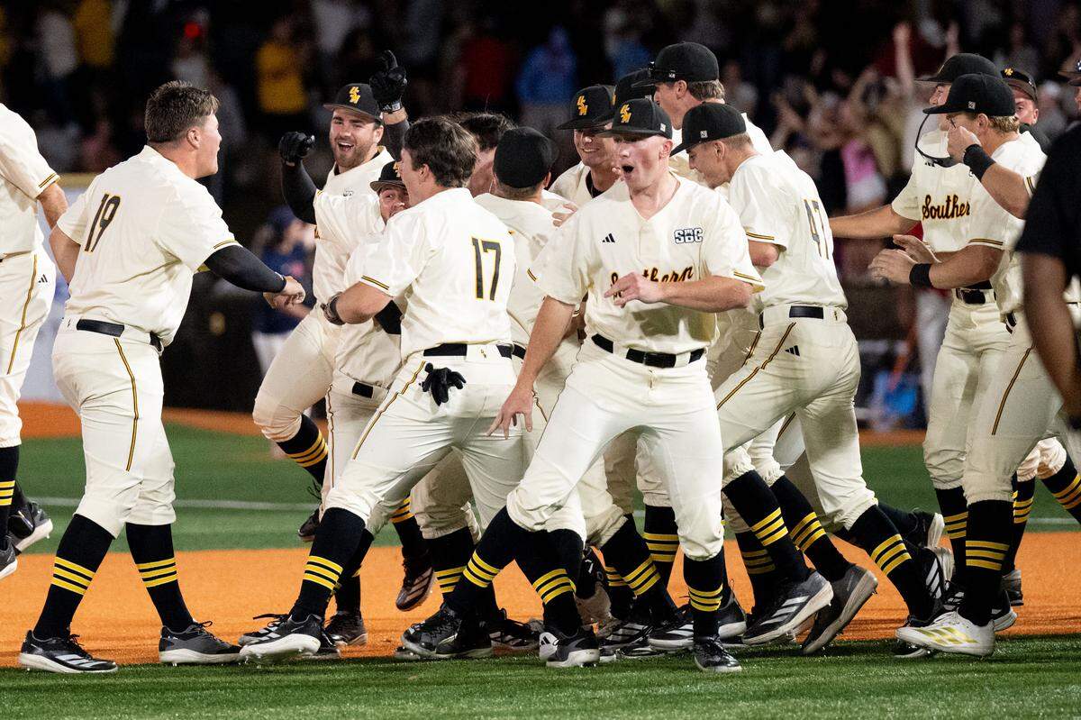 Southern Miss players celebrate a walk off score to win a baseball game at Pete Taylor Park in Hattiesburg on Tuesday, March 10, 2026.