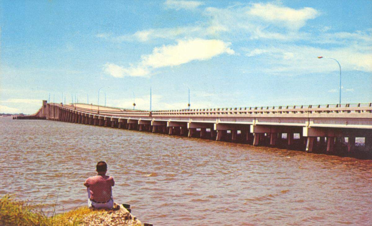 This second bridge to span Biloxi Bay was dedicated in 1962 as Biloxi-Ocean Springs Bridge. The four-laner was built higher to accommodate boats but had a draw for taller masts.