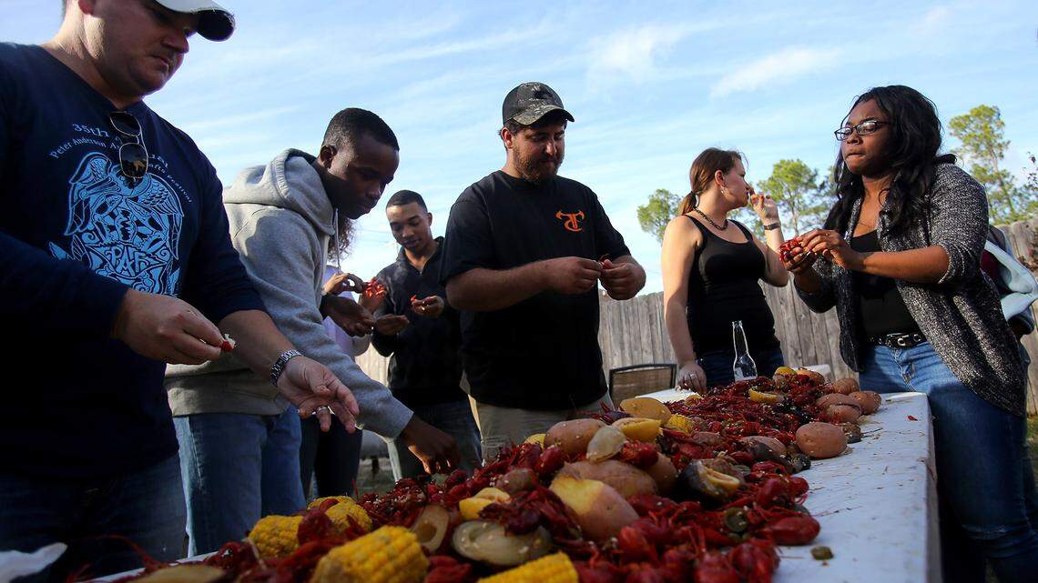Crawfish and cornhole: Ocean Springs man hosts 17 Keesler airmen for a Coast Thanksgiving 