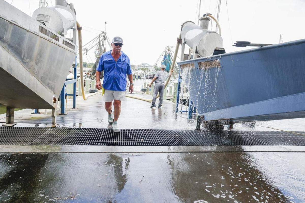 David Gautier walks past equipment used to collect and weigh shrimp from boats at Gautier’s at the Harbor in Pass Christian on Sept. 25, 2025.