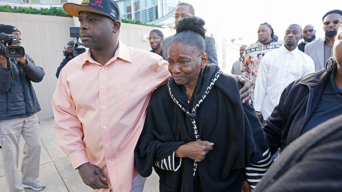 Eddie Terrell Parker, left, escorts Mary Jenkins, mother of Michael Corey Jenkins, into the Thad Cochran United States Courthouse in Jackson, Miss., Tuesday, March 19, 2024, for sentencing on two of the six former Mississippi Rankin County law enforcement officers who committed numerous acts of racially motivated, violent torture on Parker and his friend Jenkins in 2023. The six former law officers pleaded guilty to a number of charges for torturing them and sentencing begins Tuesday in federal court. (AP Photo/Rogelio V. Solis)