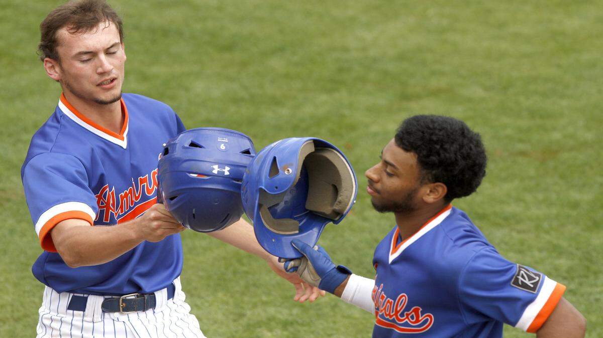 TIM ISBELL/SUN HERALD 
 Gulfport's Ethan Saucier (left) congratulates teammate Kevin Carter after he hit a sacrifice to score Saucier against Oak Grove, Saturday, March 26, 2016.