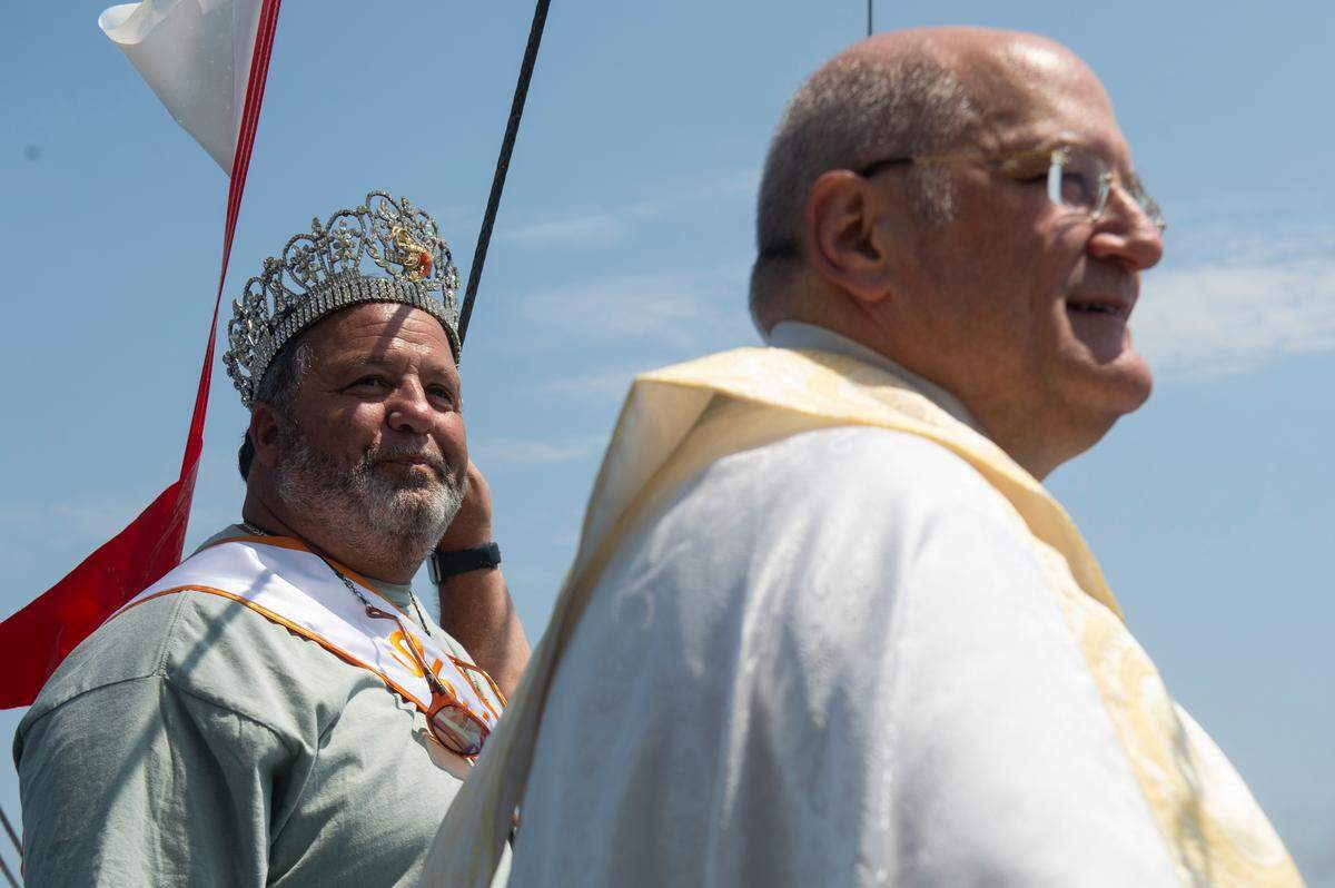 Shrimp King Wally Gollot and Msgr. Dominick Fullam, the pastor at St. Michael’s Catholic Church, during the Blessing of the Fleet in Biloxi on Sunday, May 28, 2023.