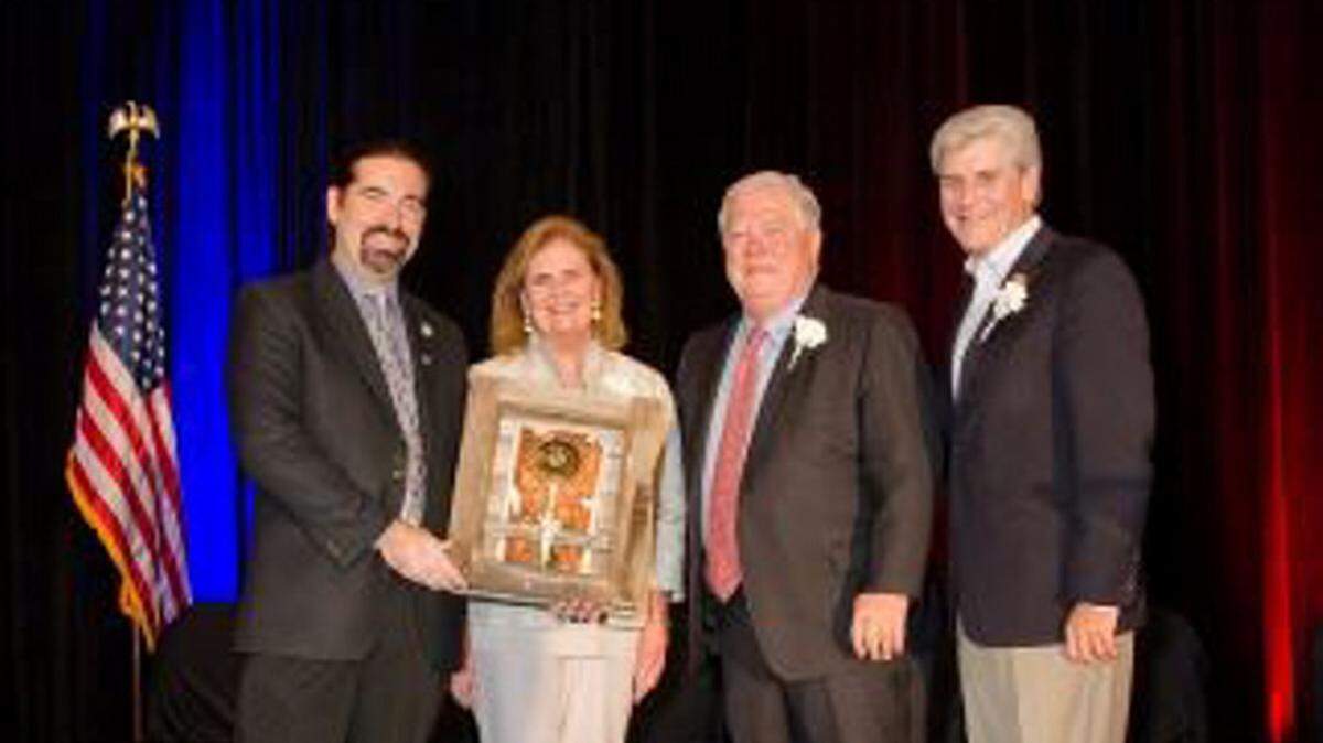 COURTESY HANCOCK CHAMBER/FILEMark Henderson, left, past president of the Hancock Chamber, presents an award to Marsha and Haley Barbour. who were recognized as Citizens of the Decade at the 2015 Annual Awards Gala, while Gov. Phil Bryant, right, looks on. Nominations are being sought for the 2016 awards.