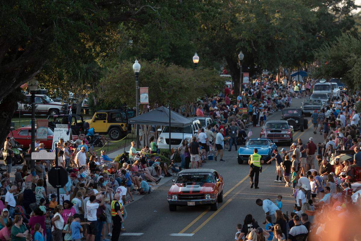 Cruisers drive down Jeff Davis Avenue during the Long Beach Parade in Long Beach, one of the events in Cruisin’ The Coast, on Monday, Oct. 7, 2024.