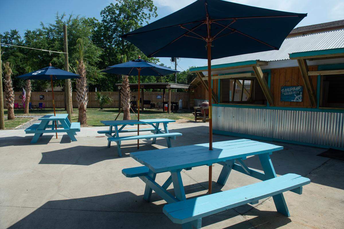 The new Back Yard beer garden behind The Blind Tiger’s Depot District Deli and Seafood Market in Bay St. Louis is where customers can order food from the deli and one of the beers on tap.