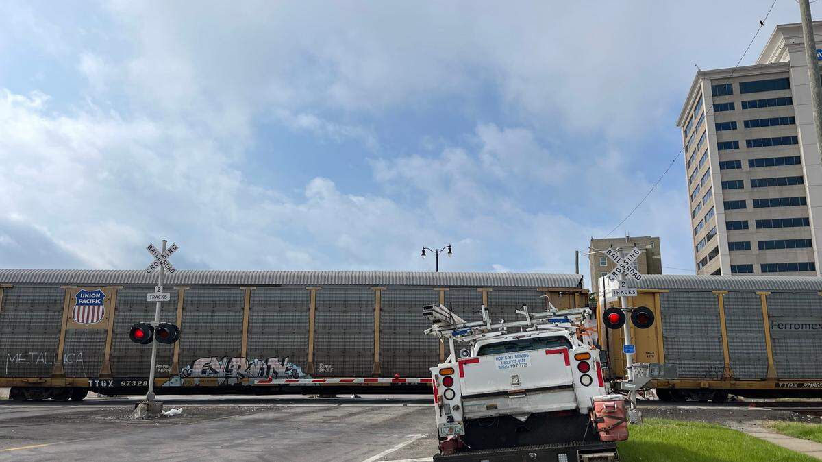 A train has halted on the tracks on Monday, May 9, 2022, blocking traffic at the 15th Avenue and U.S. 49 crossing in downtown Gulfport.