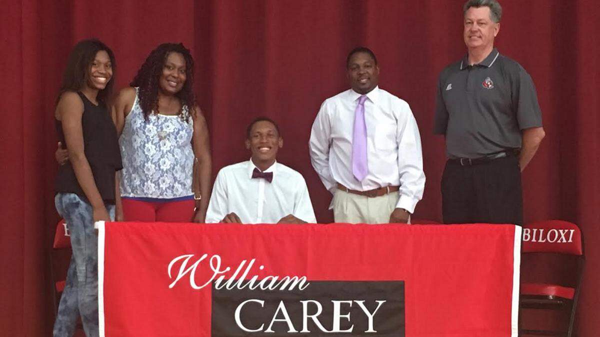 BILOXI HIGH SCHOOLBiloxi High standout Marques McGee, center, signed a scholarship with William Carey.