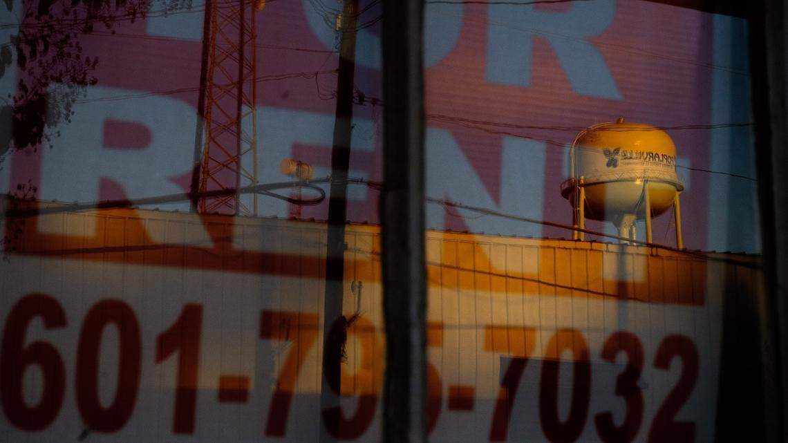 A window of a building for rent in downtown Poplarville reflects a water tower on Tuesday, Oct. 13, 2020.