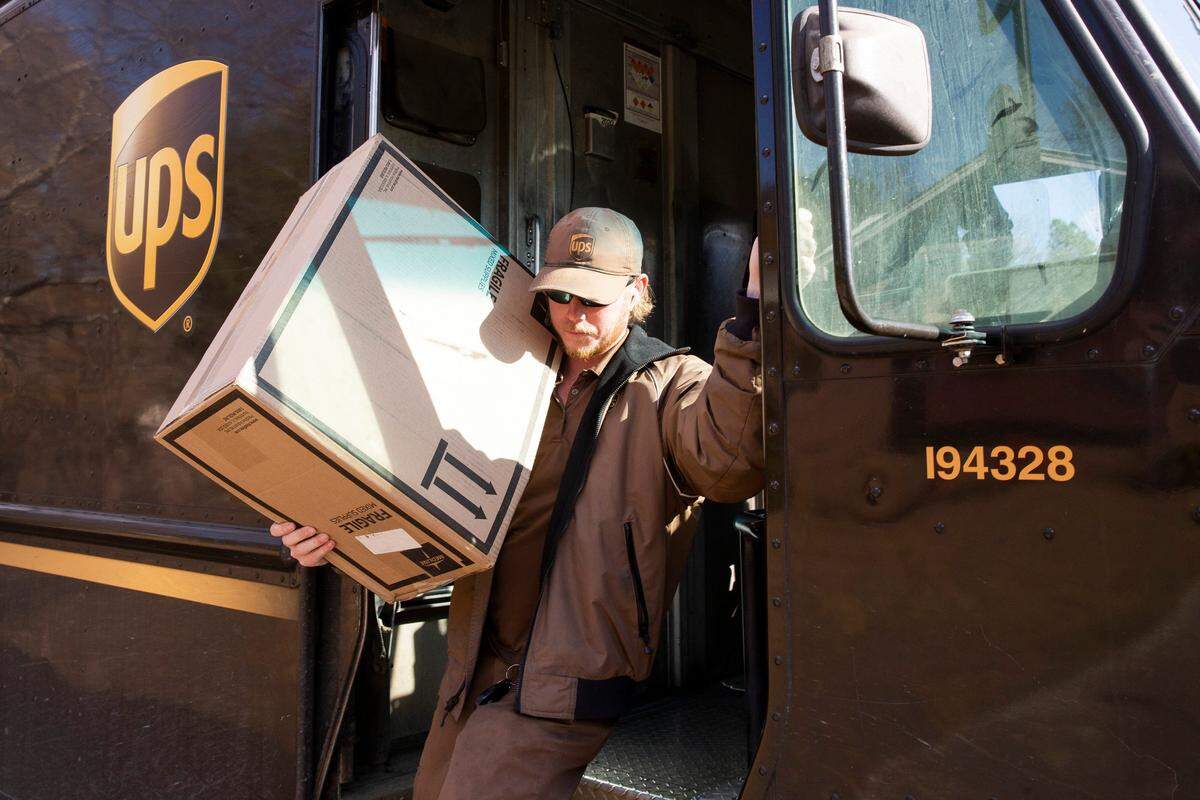 Chance Futrell carries a package out of his UPS truck while making a delivery in this file photo. Customers at two UPS Stores in South Mississippi found the locations closed this week. They can use another location of UPS Store or call UPS for pickup information.