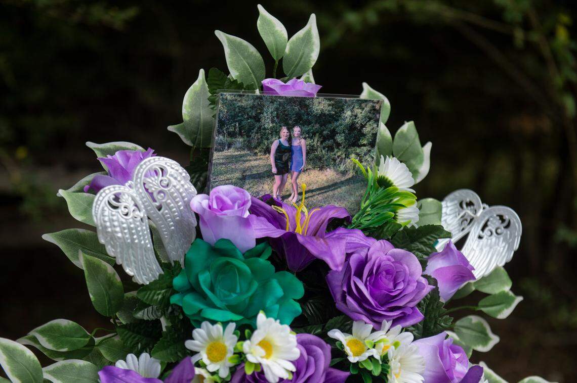 A photo of Baleigh Bowlin and Chloe Taylor sits on a memorial for the girls at the site of a fatal car accident that claimed the lives of both girls off of Highway 613 in Hurley on Monday, Oct. 17, 2022.