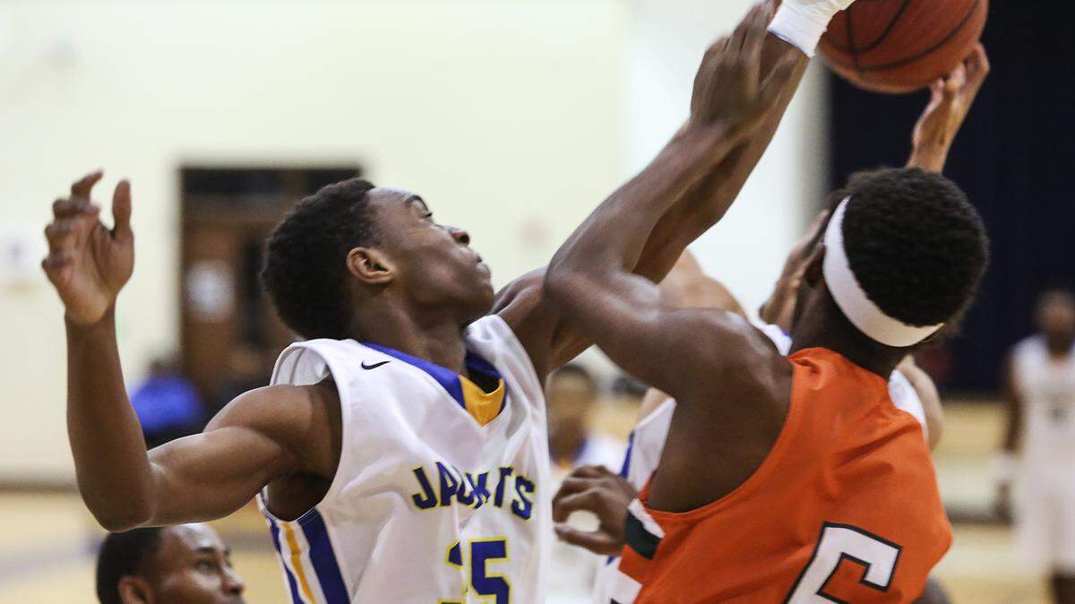 AMANDA McCOY/SUN HERALDSt. Martin's Jalen Lett and West Harrison's Gabriel Barber battle for a rebound on Tuesday, December 8, 2015, at St. Martin High.