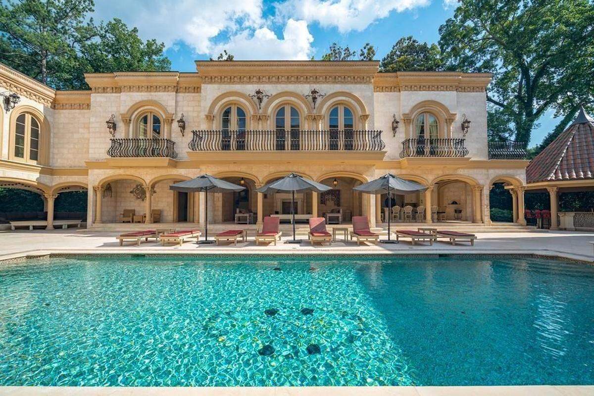 Outside, there’s a pool with two hot tubs, along with a covered patio and sitting area.