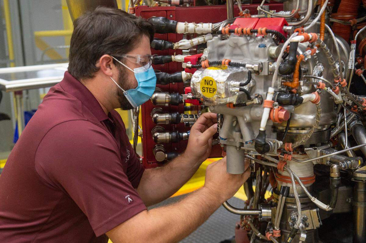Chris Ladner, an avionic engineer, works on one of the RS-25 engines at Aerojet Rocketdyne at Stennis Space Center on Monday, Aug. 8, 2022.