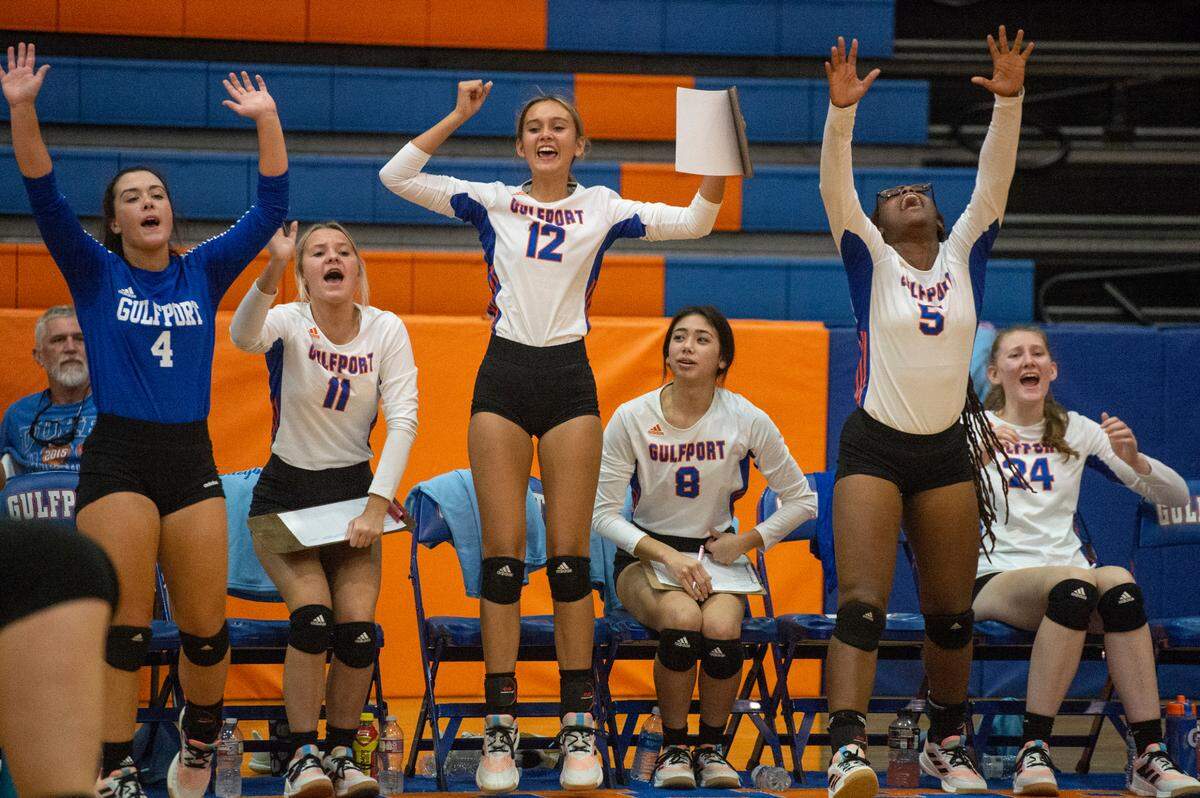 Members of the Gulfport varsity volleyball team cheer on their teammates from the sidelines after a point during a match against Ocean Springs at Gulfport High School in Gulfport on Tuesday, Oct. 4, 2022.