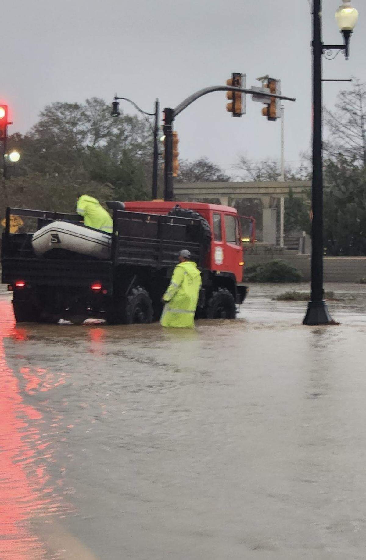 Hattiesburg PD and FD pull out a row boat to reach people in the flooding streets of Hattiesburg Friday evening.
