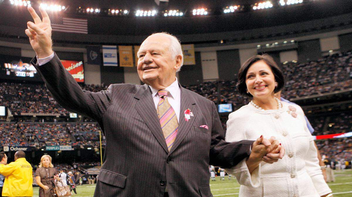 BILL HABER/AP 
 New Orleans Saints owner Tom Benson and his wife Gayle Benson wave to the crowd before the start of the New Orleans Saints-New York Jets NFL football game in New Orleans, Sunday, Oct. 4, 2009.