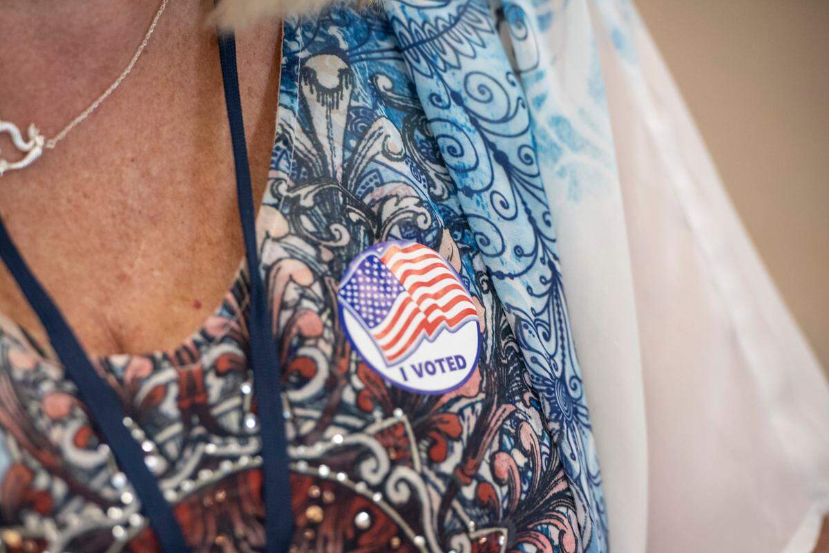 Poll worker Deenie Swarthout wears a voting sticker during the primary election at the D’Iberville Civic Center in D’Iberville on Tuesday, June 7, 2022.