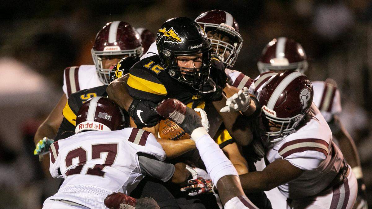 D’Iberville’s Colton Deshazo is tackled by Picayune as he carries the ball down the field during the D’Iberville versus Picayune game at D’Iberville Stadium on Friday, Sept. 17, 2021.