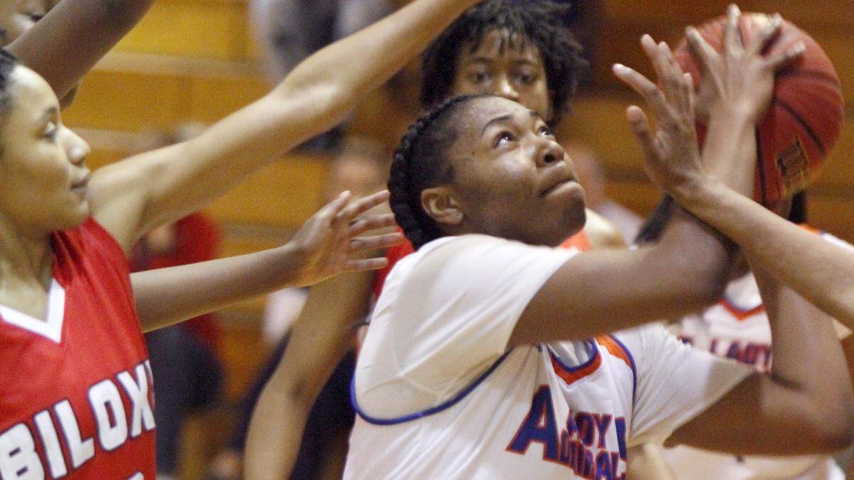 TIM ISBELL/SUN HERALD 
 Gulfport's Aarmanii McDaniel navigates numerous arms to take a shot under the goal against Biloxi, Tuesday, Feb. 16, 2016.