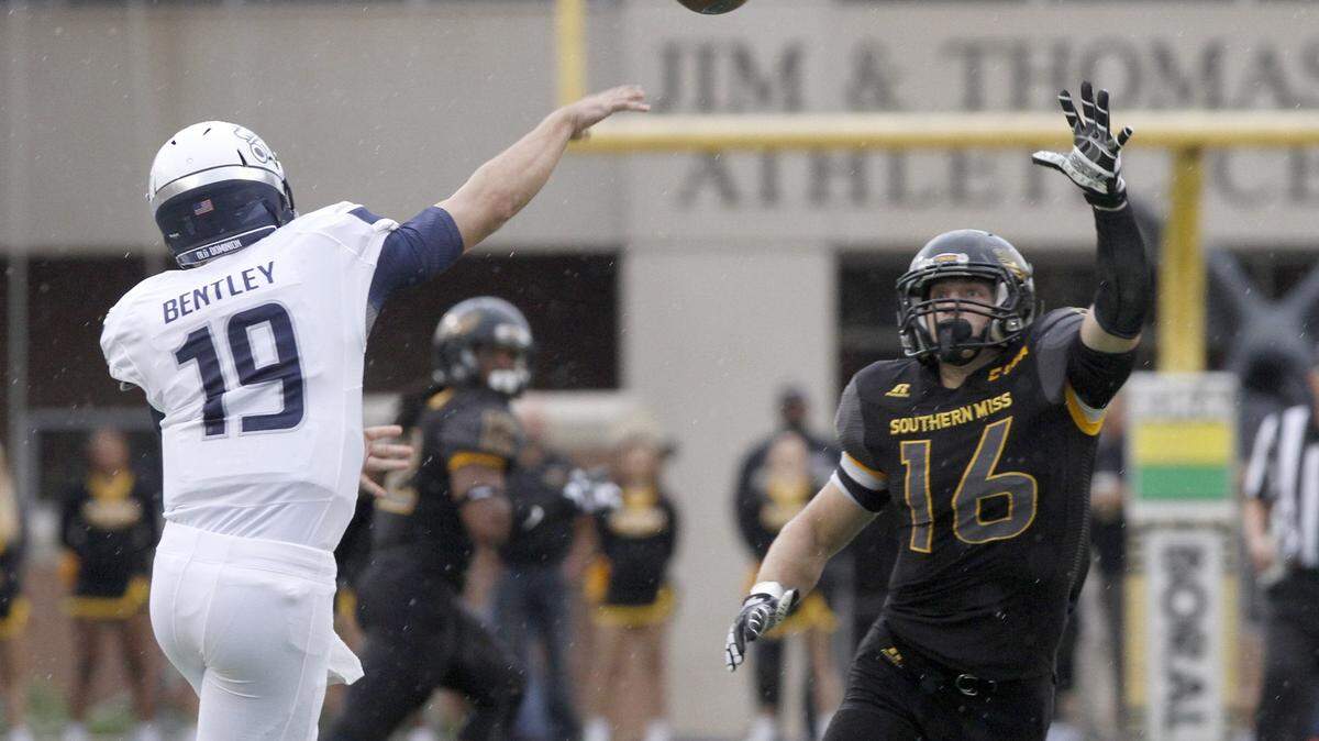TIM ISBELL/SUN HERALD 
 Southern Miss linebacker Elijah Parker tries to block the pass of Old Dominion quarterback Shuler Bentley, Saturday, Nov. 21, 2015.