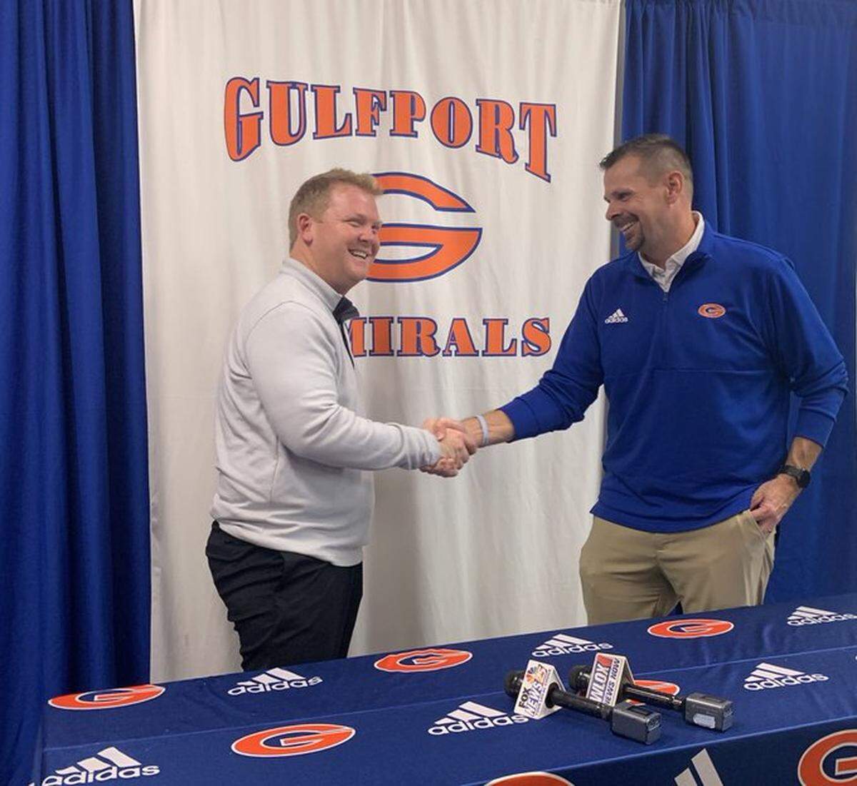 Newly minted Gulfport football coach Blake Pennock shakes hands with Admiral athletic director Matt Walters at Pennock’s introductory press conference on Jan. 9, 2023.