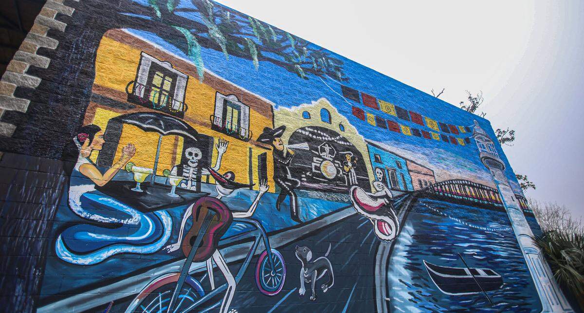 A mural was painted on the side of building that houses Rooftop Taco & Tequila Bar in downtown Ocean Springs. The owner has purchased the neighboring building and will build a restaurant with vacation rentals above.