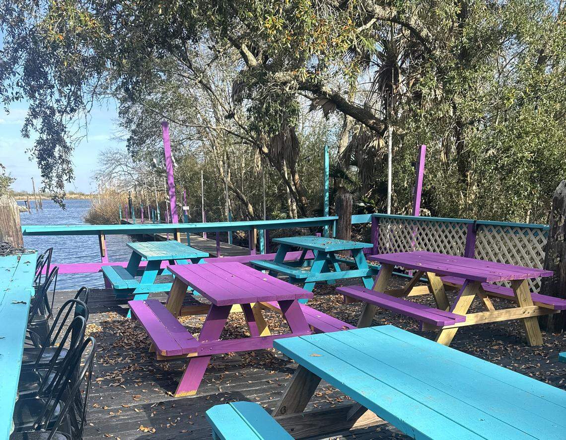 Colorful picnic tables in the sun or under an umbrella are other choices for sitting with a plate of fish at the new Crawfish House on the Bayou in Gautier.