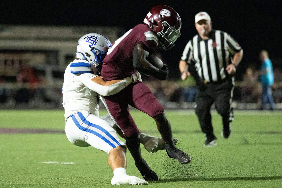 Picayune Memorial running back Xavier Dennis (9) is tackled in the open field during a football game at Picayune Memorial High School on Friday, Sept. 19, 2025.  Ocean Springs won the game 56-42.