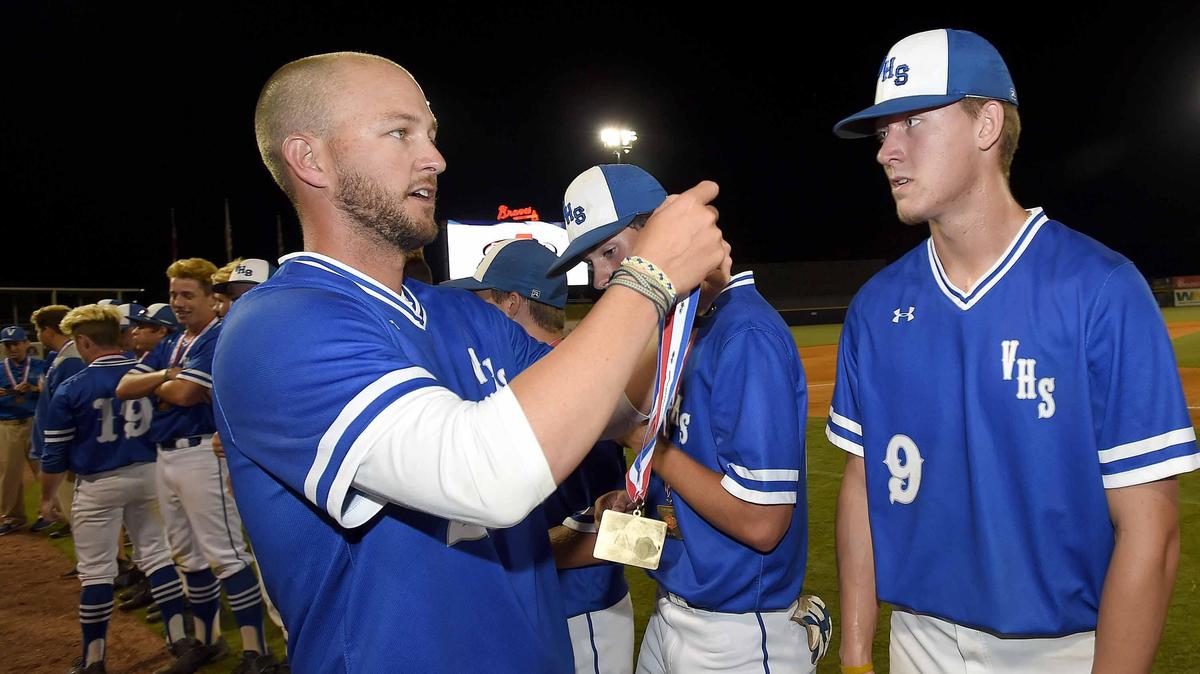Vancleave head coach Daniel Best (left) prepares to give Justin Stokes (9) his gold medal on Friday, May 18, 2018, in the MHSAA State Baseball Championships at Trustmark Park in Pearl, Miss. Best has been hired to take over the Brandon High School baseball team.